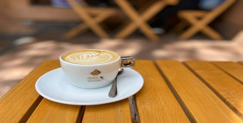 قهوه سرو شده در کافه Coffeestory ایروان – نوشیدنی گرم روی میز چوبی